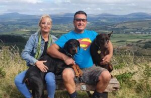 Doberman Dog Sniffs Out Organ Donor To Save Owner’s Life Lucy and Cenydd with life saver Indie and big Dave the Doberman Image Lucy Humphrey Instagram