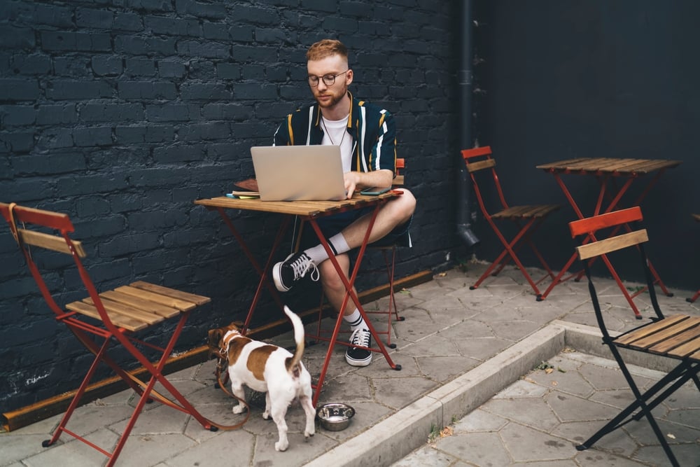 Digital Nomad working outdoors with a dog